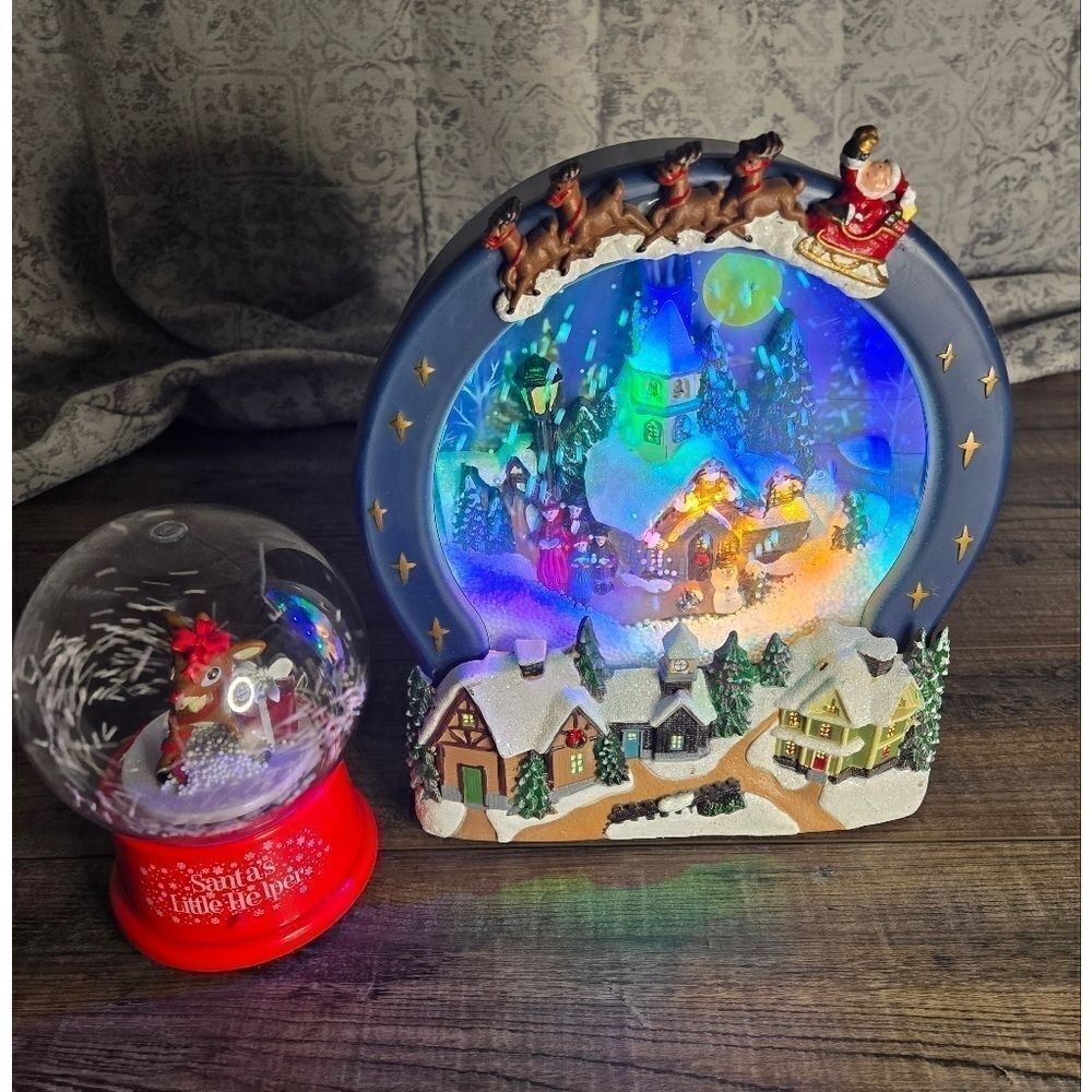 Two snow globes, animated snow, one is musical  and lights up htf